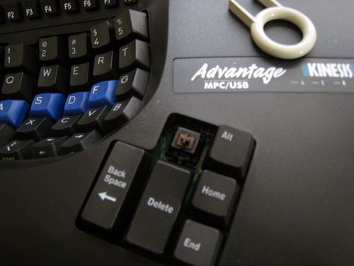 The tool used to remove keycaps is at the upper right; putting Mac-labeled keys on was easy.
